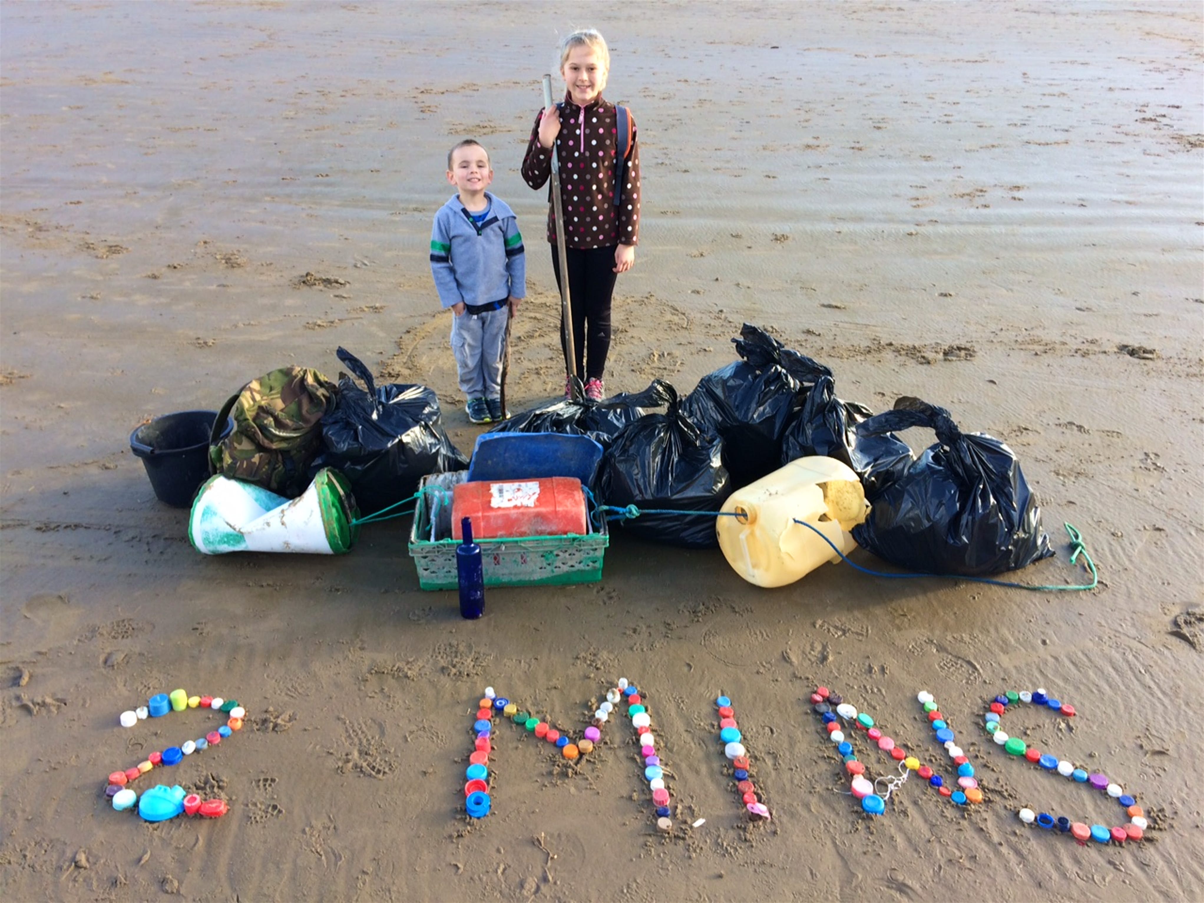 Isaac Rees and Emi Chubb with rubbish collected in a two minute spell. image courtesy of Julie OShea